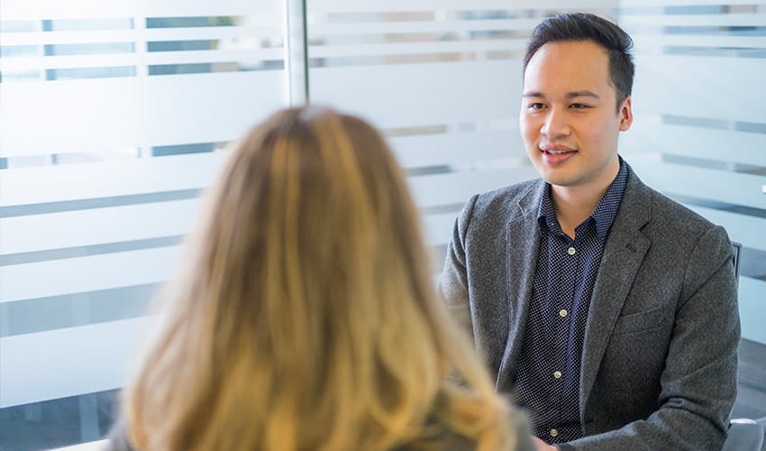 A job applicant sits in an interview at the TransLink office, discussing opportunities with a recruiter.