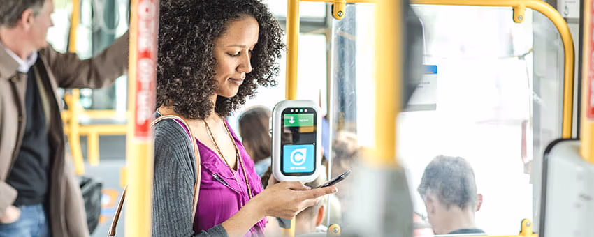 Passenger using the TransLink website on the bus