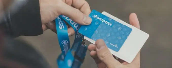 Close-up of a customer pulling a compass card out of a lanyard sleeve