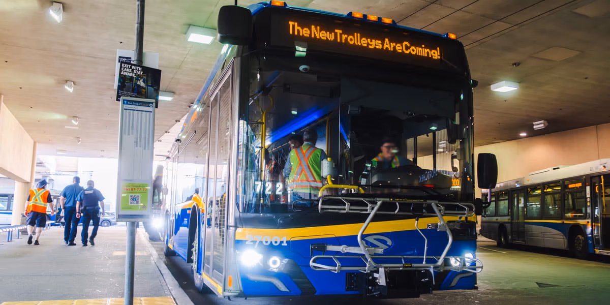 Solaris trolleybus parked at Metrotown bus loop with the words "The new trolleys are coming!"