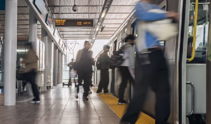 Riders boarding a SkyTrain heading towards Waterfront