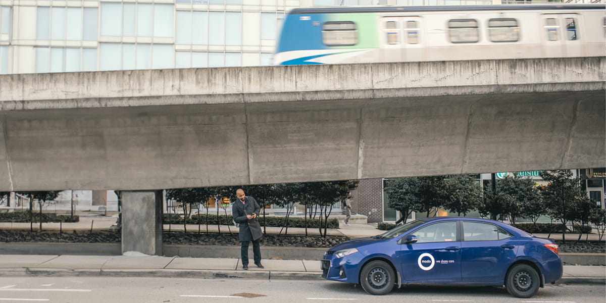 Modo vehicle parked next to the Canada Line