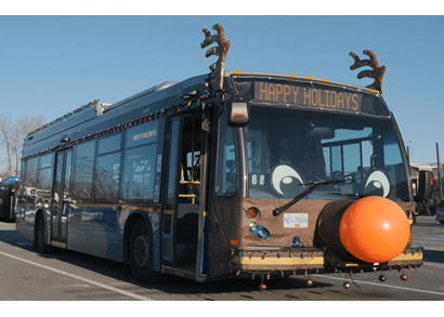 A bus with a red nose and reindeer antlers