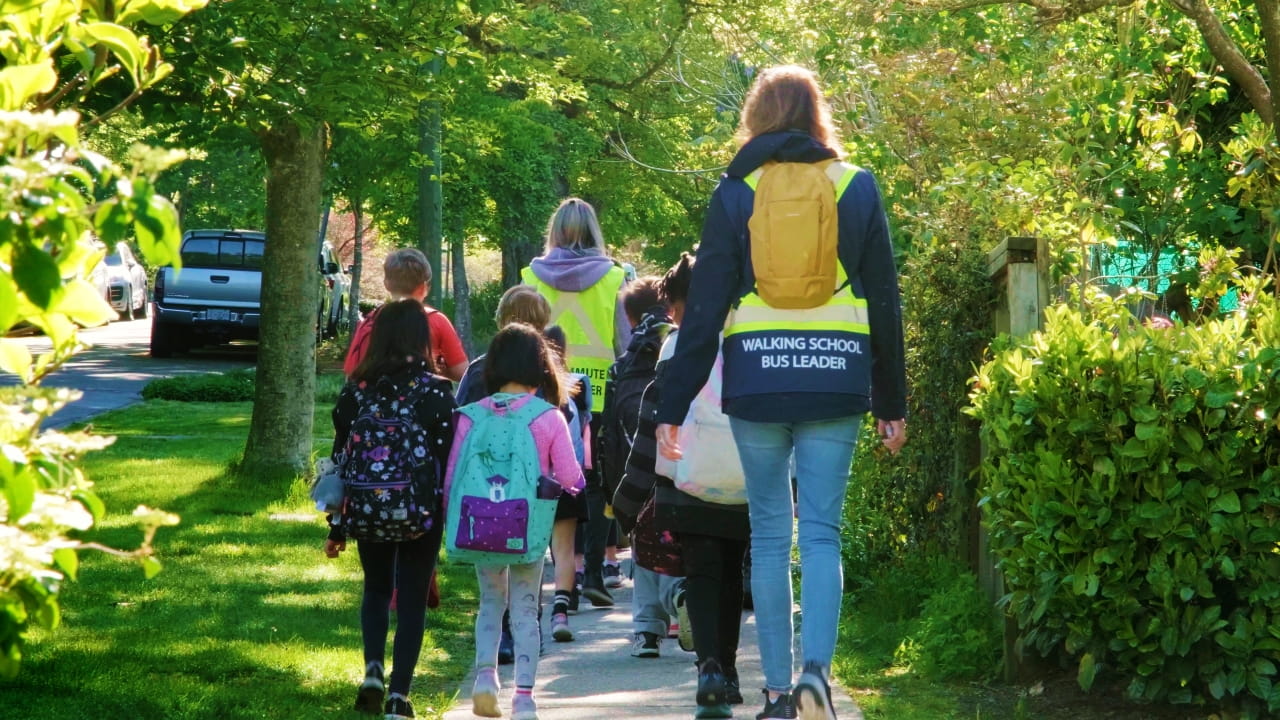 Walking School Bus in action with a Walk Leader supervising a group of children