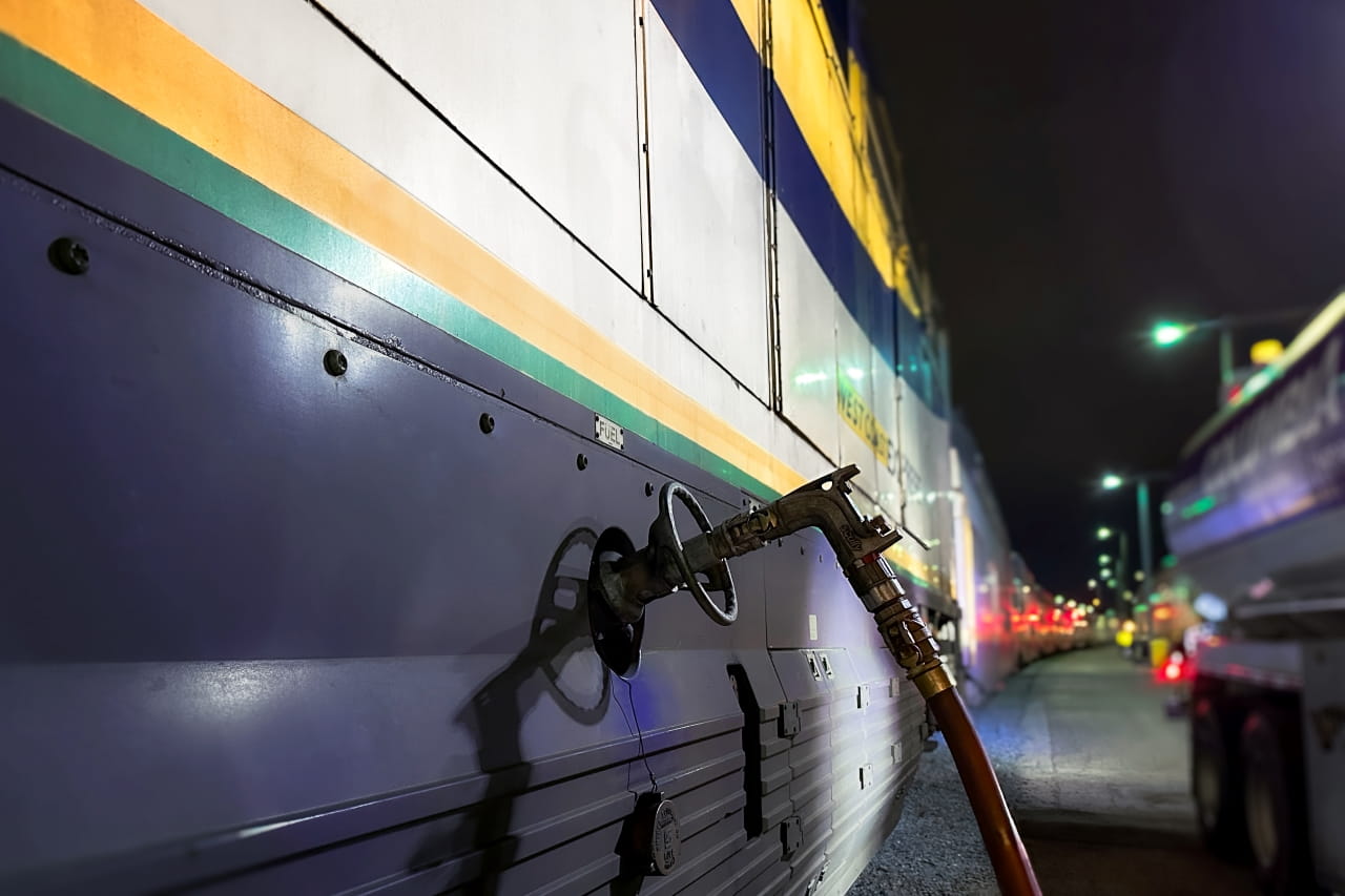 The West Coast Express locomotive being filled up with renewable diesel as it sits in the train yard